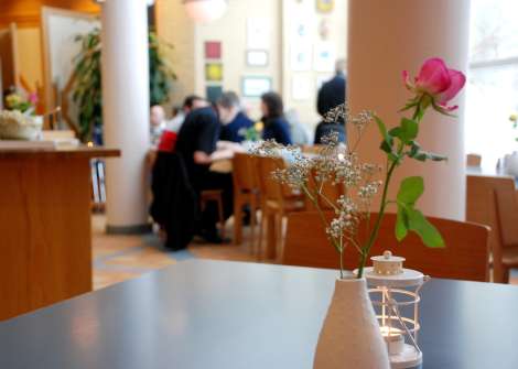 Cafébord dekorerad med en blomma i vas